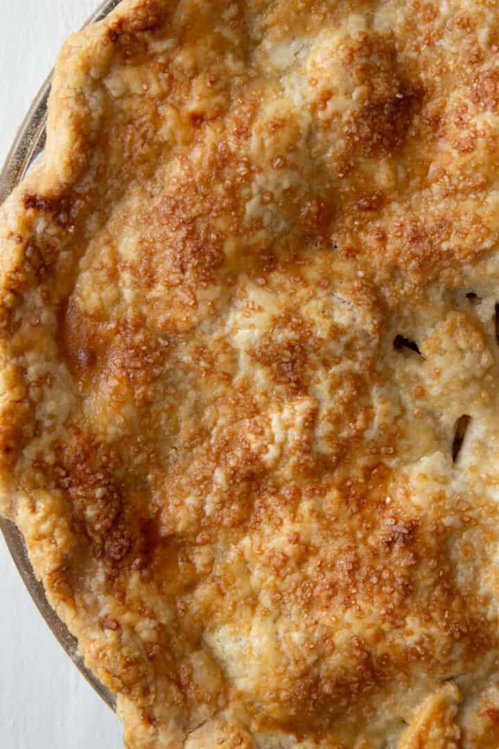 golden brown top of a pie crust with turbinado sugar on top.