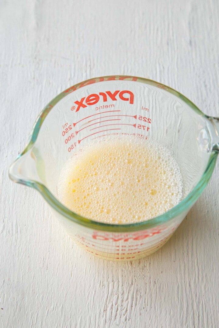 an egg and water mixture in a glass cup.