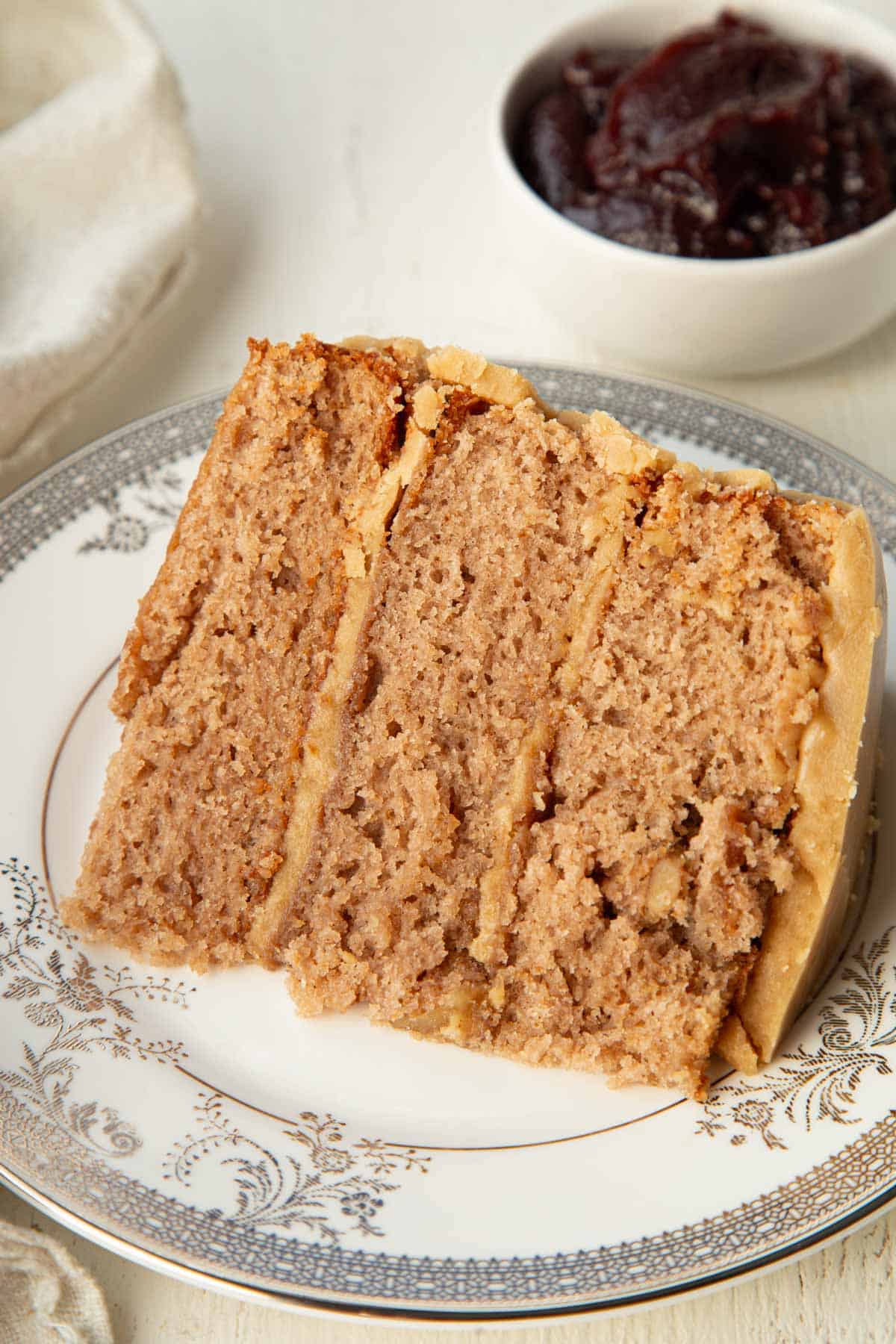 slice of three layer cake with caramel icing in the middle and on the outside.