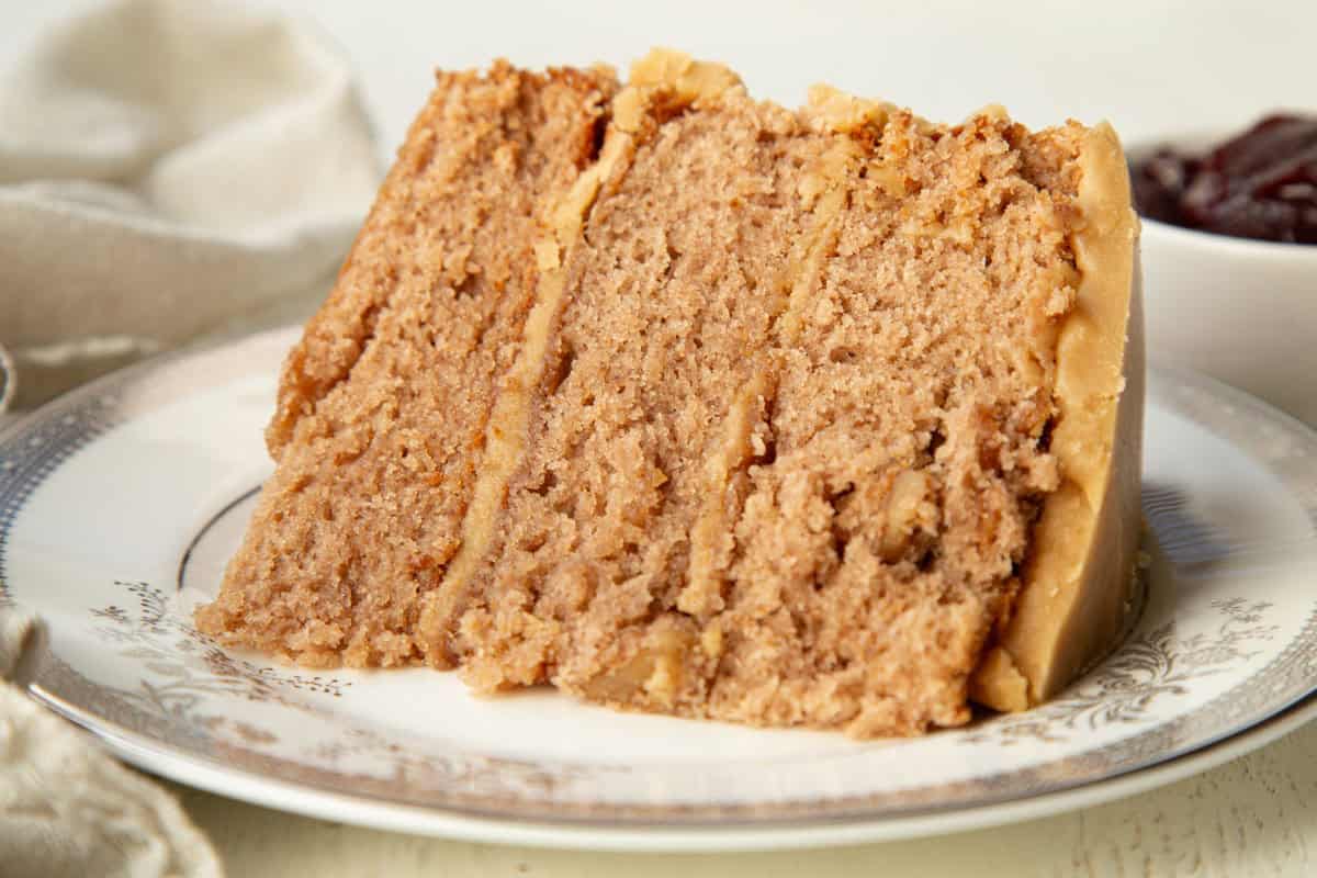 slice of kentucky jam layer cake with three layers on a white plate.