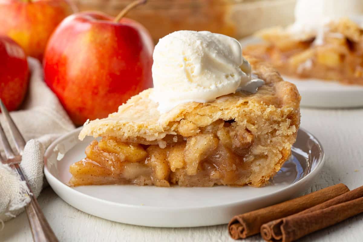 slice of apple pie topped with a scoop of ice cream.