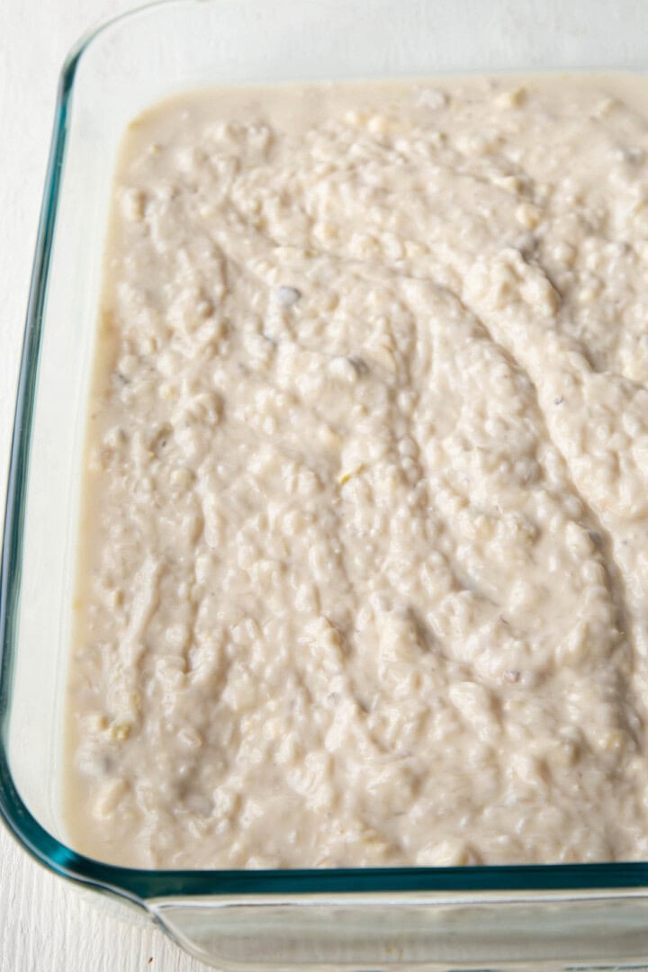 rice and cream of mushroom soup mixed together in a glass casserole dish.