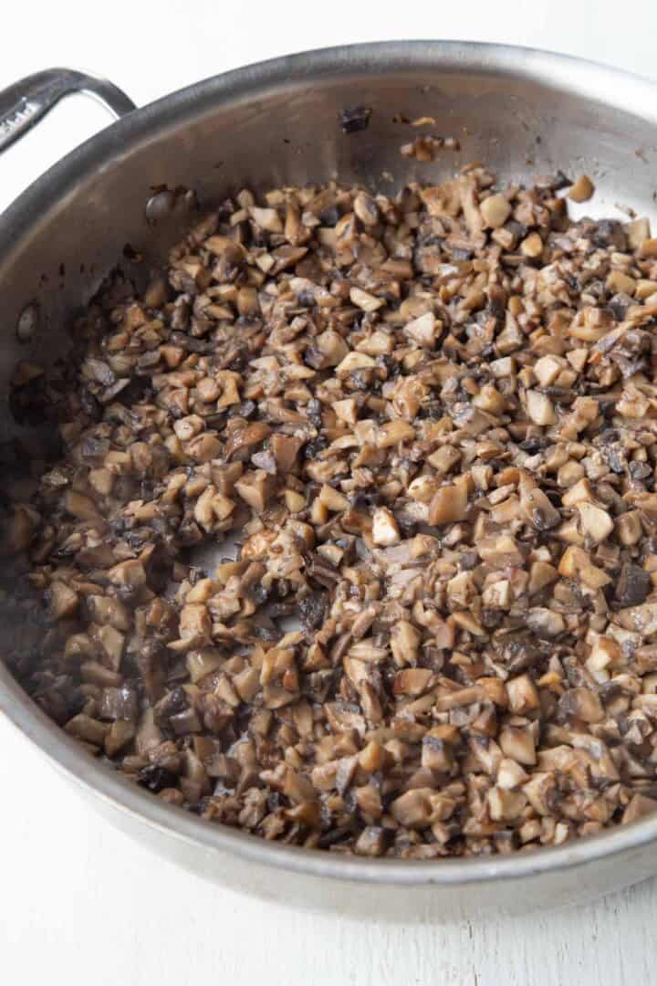 cooked chopped mushrooms in a skillet.