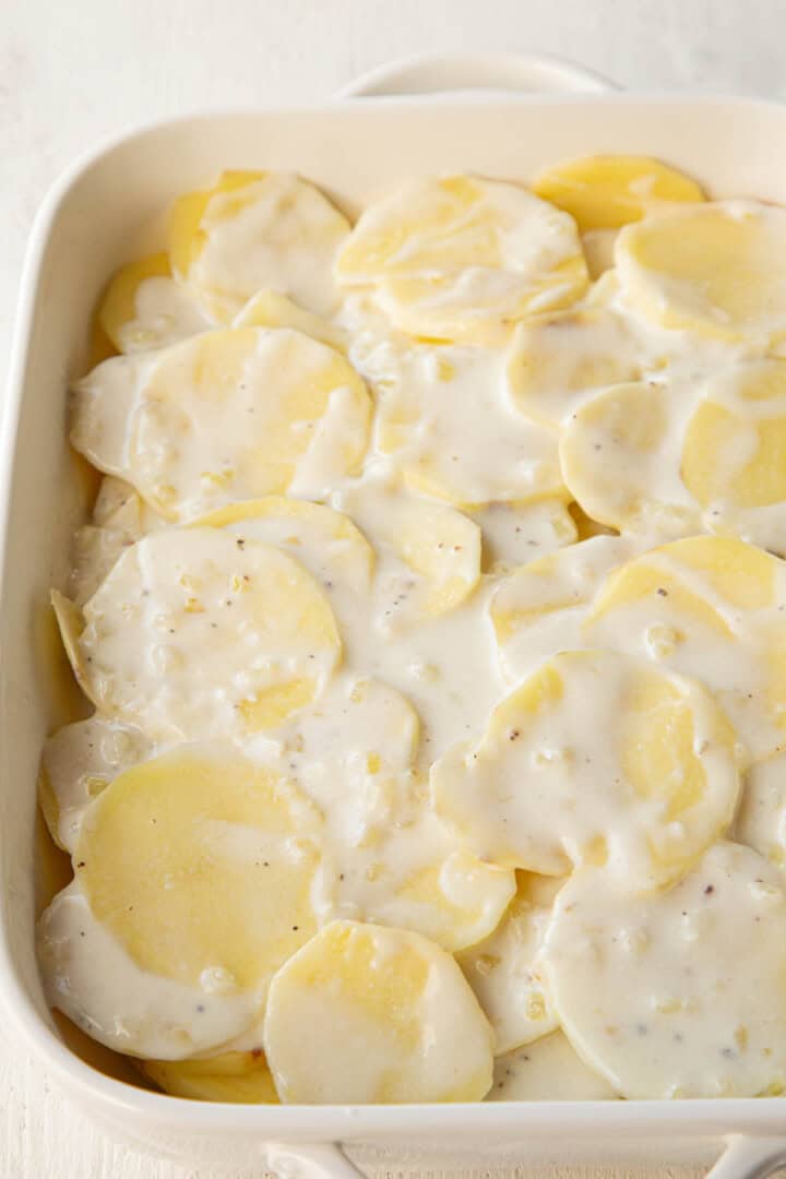 raw potato slices covered in a white cream sauce.