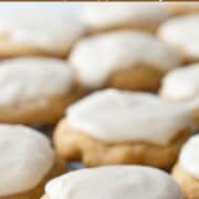 soft cookies topped with a white icing sitting on a wire rack.