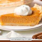 slice of pumpkin pie topped with a dollop of whipped cream.