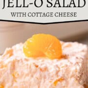slice of fluffy, creamy gelatin salad with mandarin oranges inside and on top.