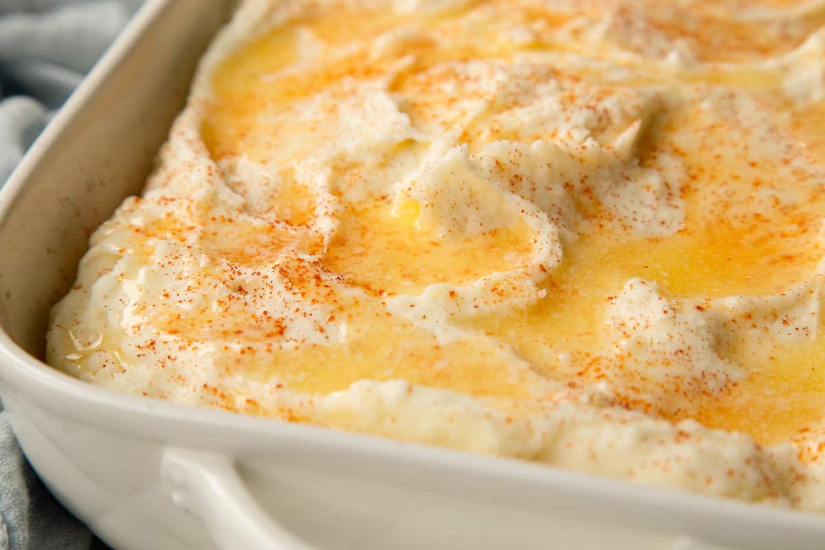 baked mashed potatoes topped with melted butter and paprika.
