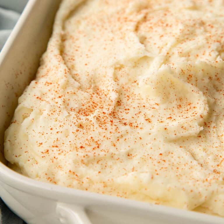creamy mashed potatoes topped with a dusting of paprika.