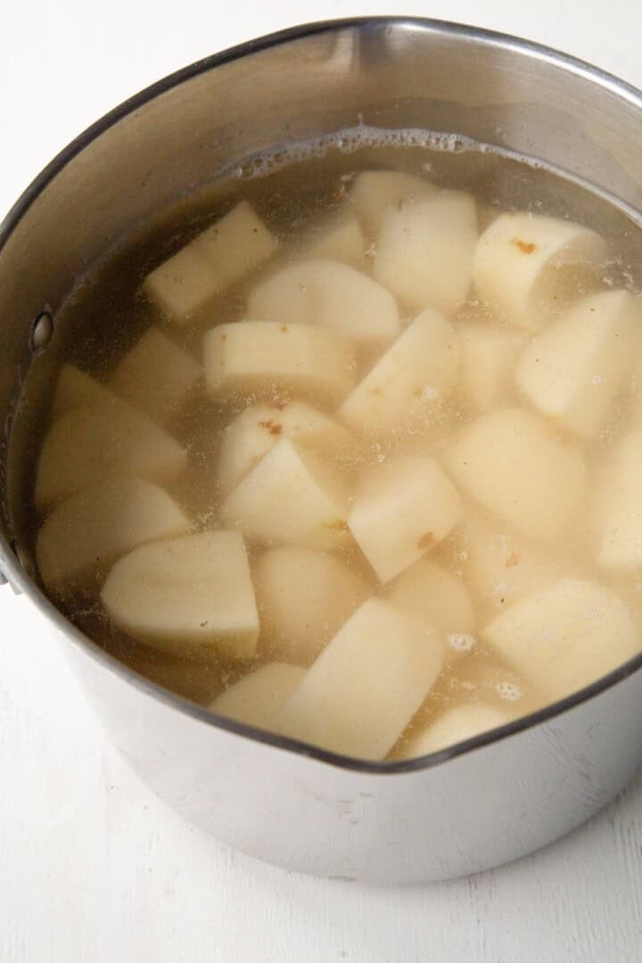 pot full of cubed potatoes and water.