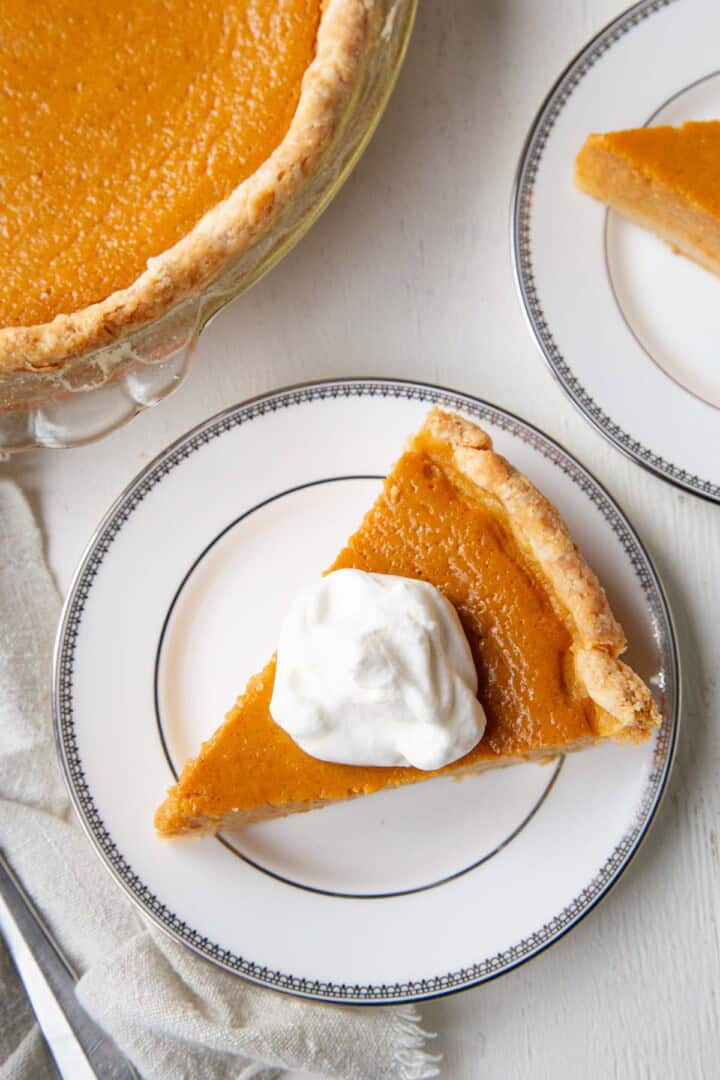 slice of pumpkin pie topped with whipped cream.