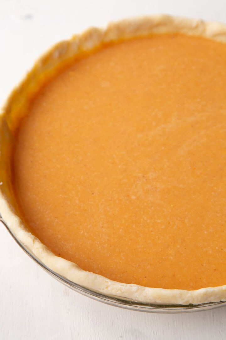uncooked pumpkin mixture in an unbaked pie shell.