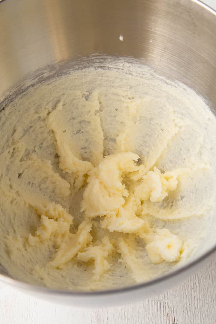 butter and sugar creamed together in a metal bowl.