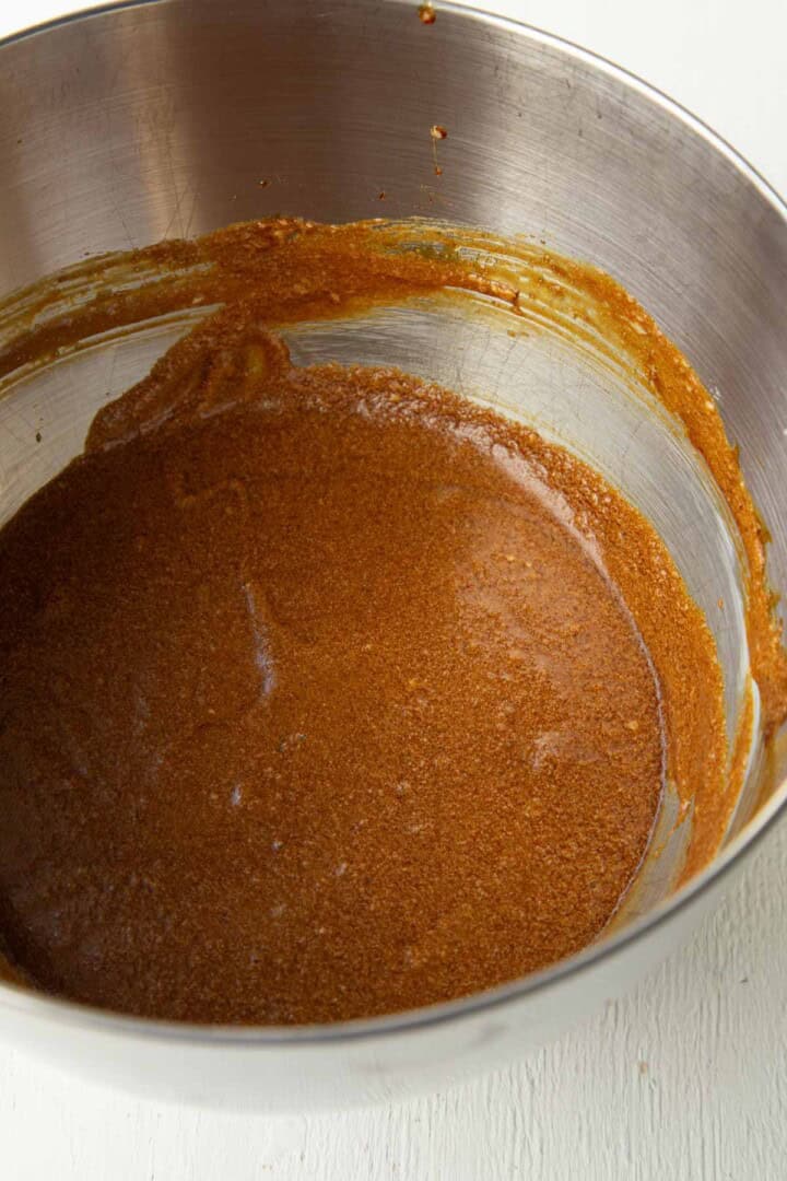 molasses mixed with eggs, butter, and sugar in a bowl.