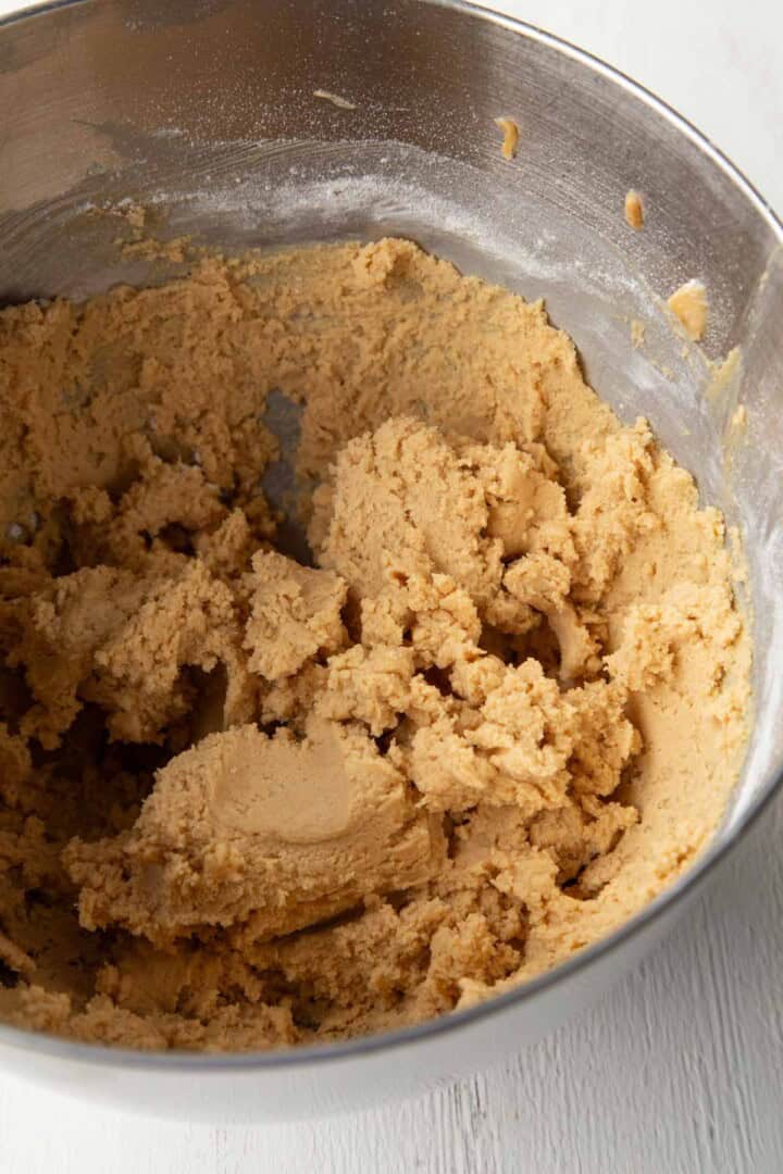 peanut butter cookie dough in a metal bowl.