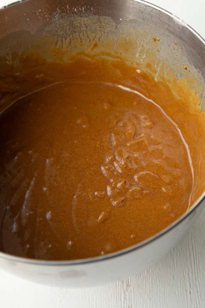caramel-colored cake batter in a metal bowl.