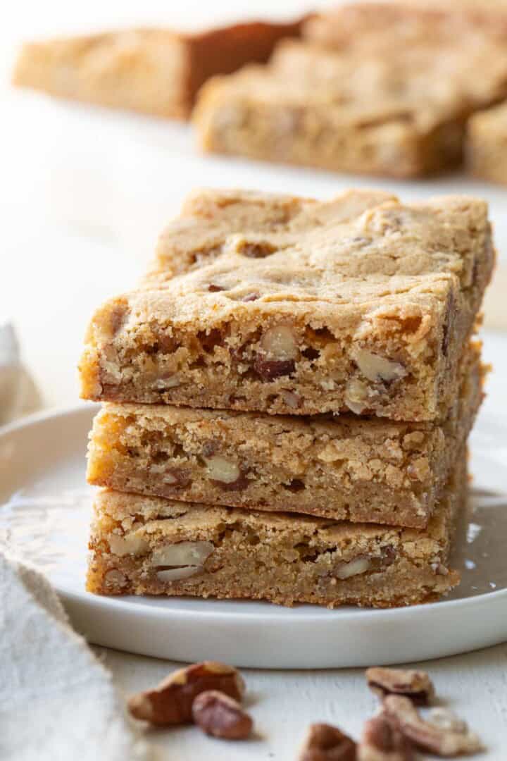 stack of three blondies with pecans inside.