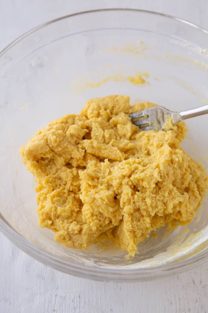 cake mix and butter mixed together in a glass bowl.