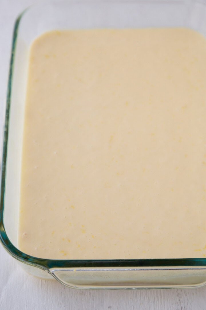 cream cheese liquid mixture in a glass baking dish.