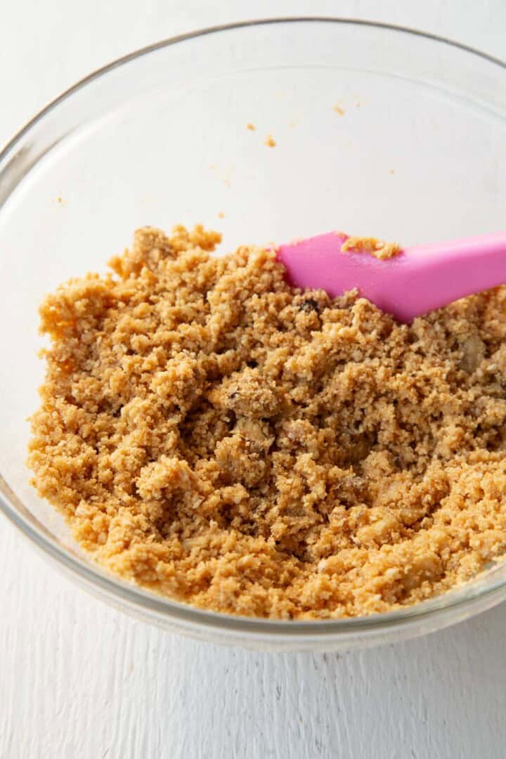 graham cracker crumbs and chopped nuts in a glass bowl.
