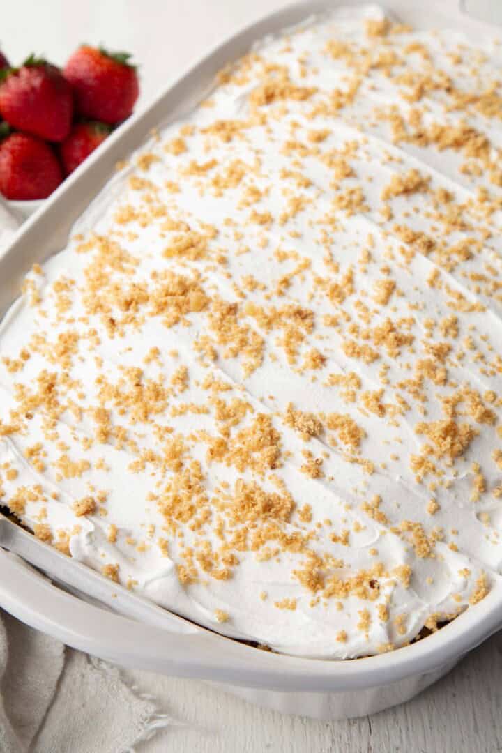 whipped topping on a 13x9inch cake, topped with graham cracker crumbs.