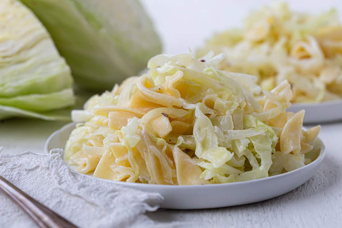 plate filled with cabbage and egg noodles.