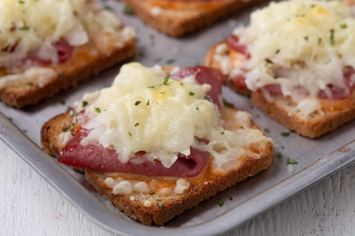 corned beef and swiss cheese on a square slice of rye bread.