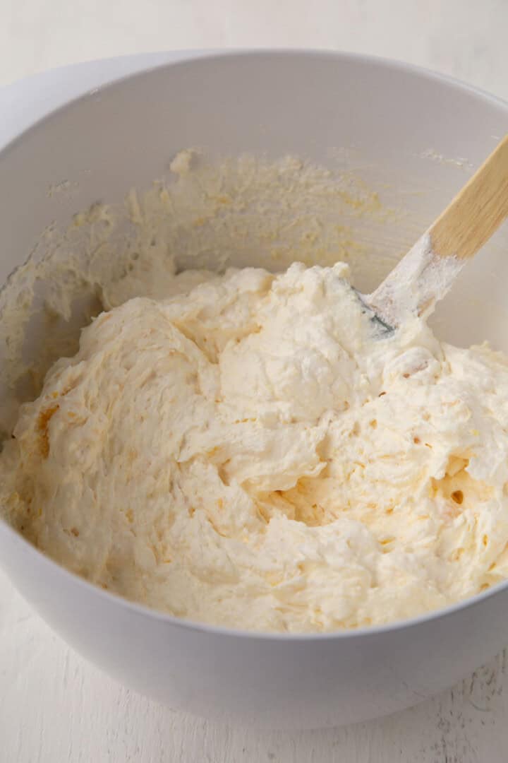 fluffy pineapple frosting in a mixing bowl.