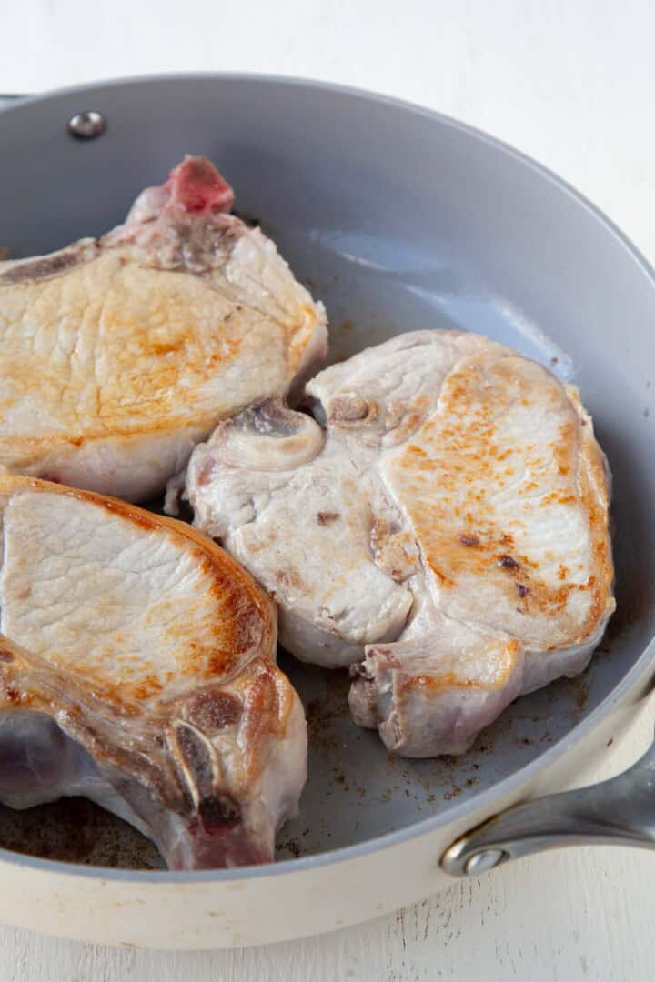 lightly browned pork chops in a skillet.