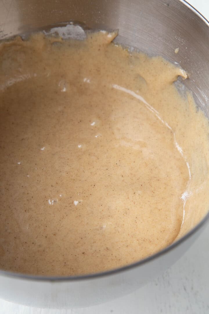 brown batter with cinnamon in a metal bowl.