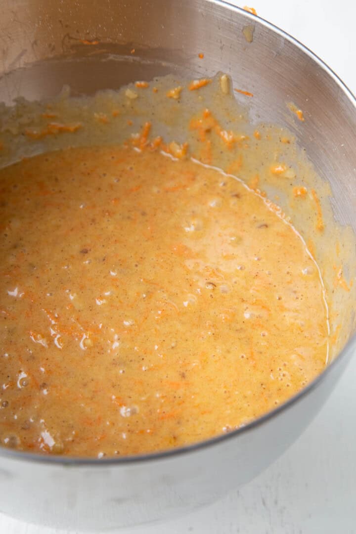 batter with carrots in a metal bowl.