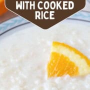 bowl of rice pudding with an orange segment on top.