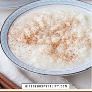 bowl of rice pudding with cinnamon sprinkled on top.