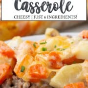 a scoop of a creamy casserole including ground beef in a creamy sauce, topped with chopped potatoes and chopped carrots, and cheese on top.