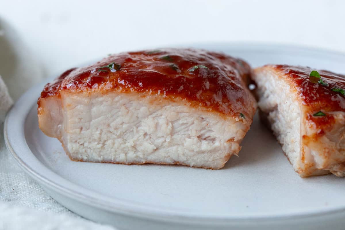 inside of a pork chop covered in bbq sauce.