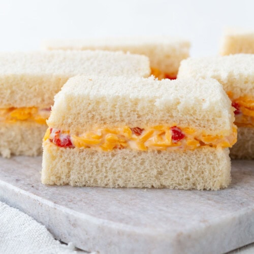 pimento cheese in between two slices of white sandwich bread, cut into thin slices.
