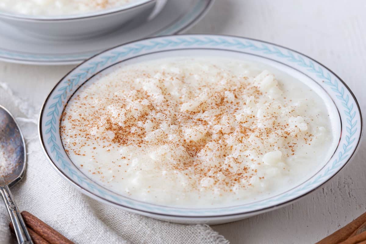 bowl of creamy rice pudding topped with ground cinnamon.