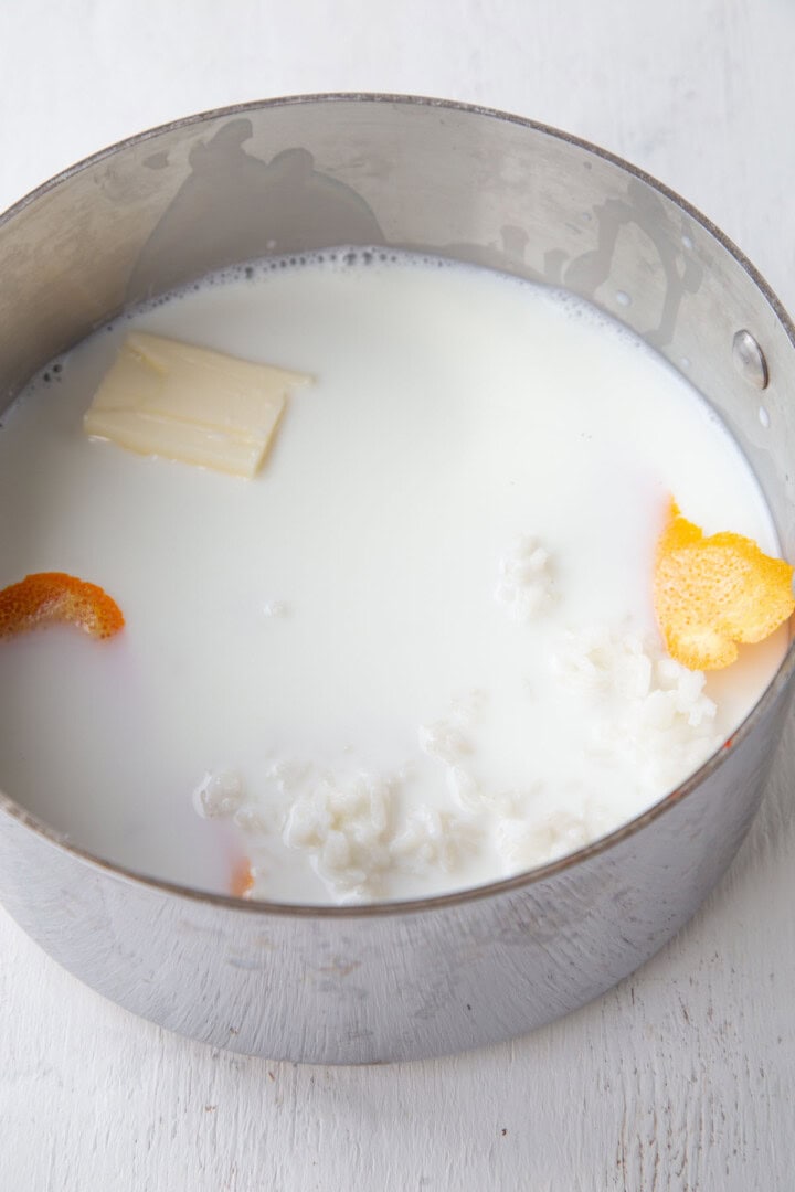 milk, butter, rice, and orange peel in a saucepan.