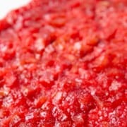 whole rhubarb upside down cake with a bright pink rhubarb topping and yellow cake underneath.