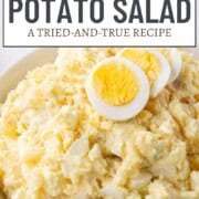 creamy potato salad topped with hard boiled egg slices.