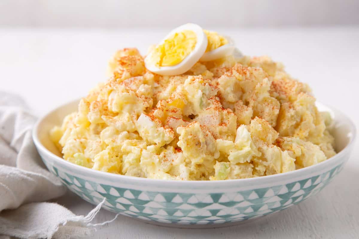 potato salad topped with paprika and hard boiled eggs.