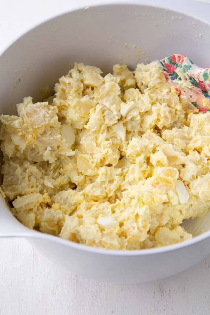chopped potatoes, celery, and onions mixed in a creamy light yellow mayonnaise dressing.