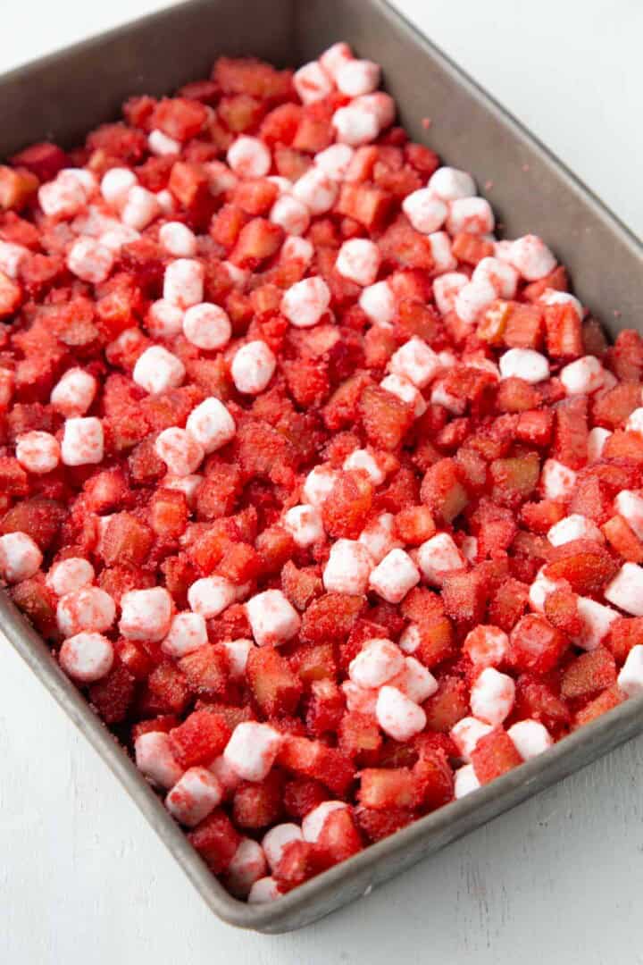 rhubarb, strawberry gelatin powder, sugar, and mini marshmallows in a baking dish.