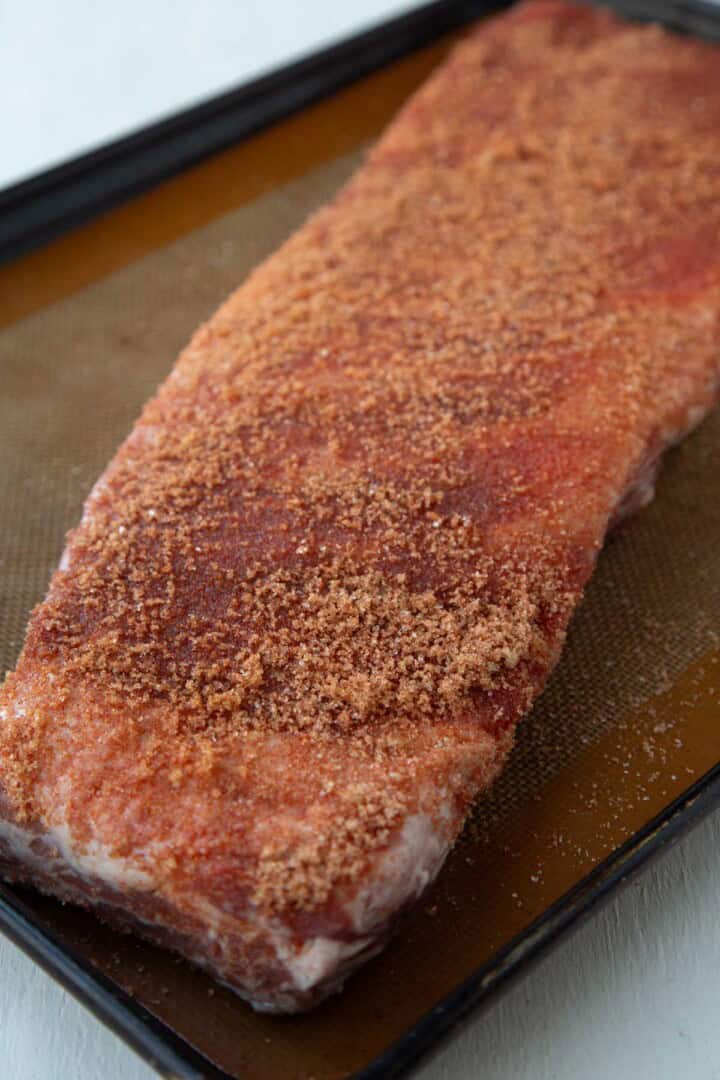 uncooked ribs covered in a brown sugar bbq rub.