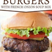 burger made with french onion soup on a bun with tomato and lettuce.