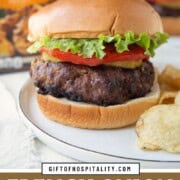 burger made with french onion soup on a bun with tomato and lettuce.