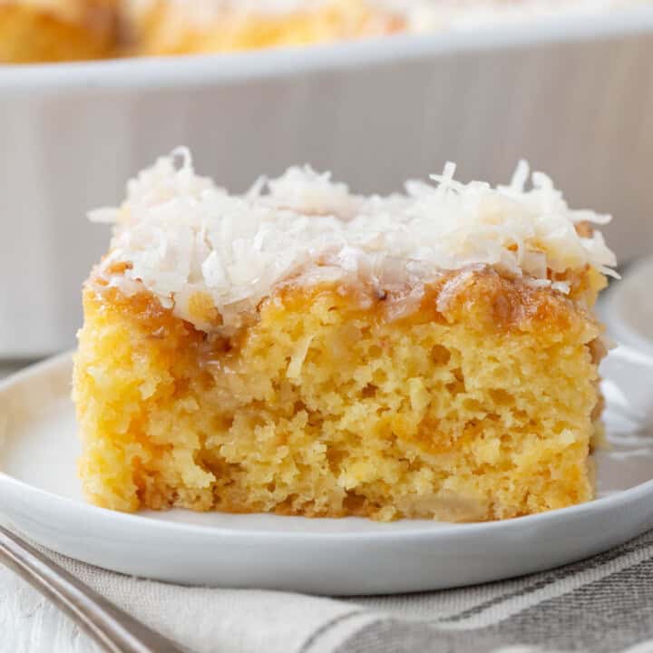 slice of ugly duckling cake: a yellow cake slice with shredded coconut on top.