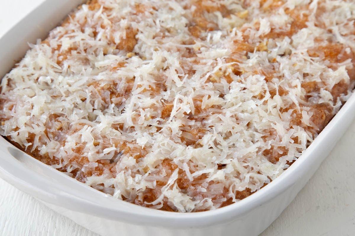 whole yellow ugly duckling cake topped with shredded coconut.