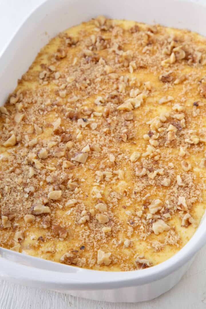 brown sugar and nuts on top of cake batter in a 13x9 inch dish.