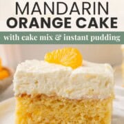 slice of mandarin orange cake topped with cool whip and a mandarin orange slice.